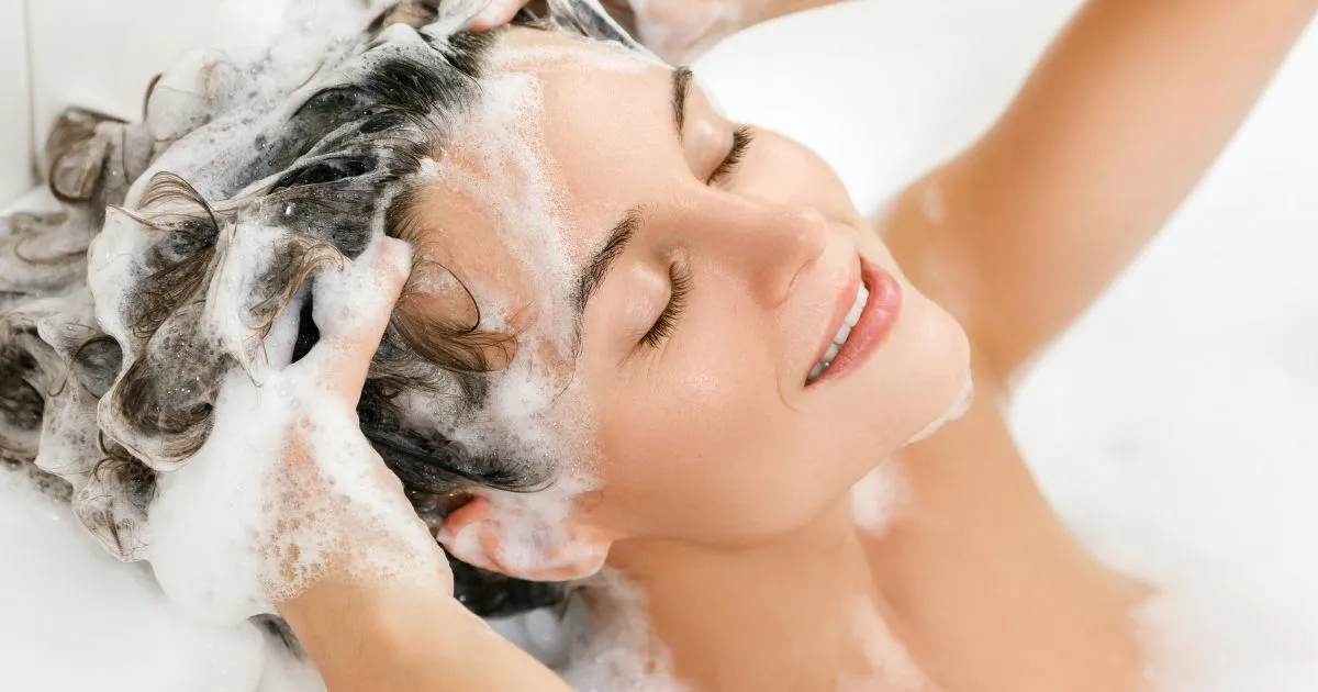 Woman Is Washing Her Hair with Paraben and Sulphate-free Shampoo Woman Is Washing Her Hair with Paraben and Sulphate-free Shampoo
